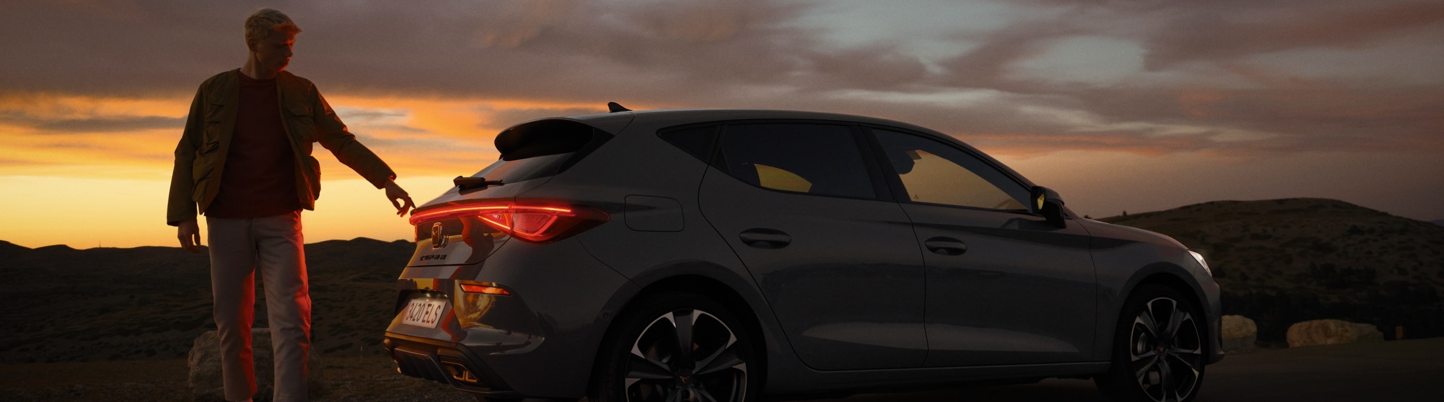 man-standing-in-front-of-cupra-leon-sp